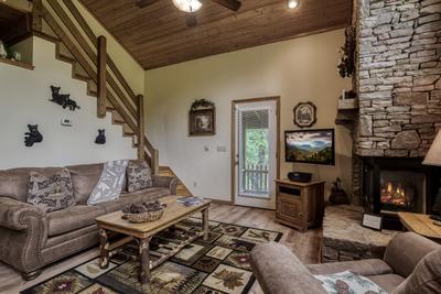 Reflections - Living room with stone encased gas fireplace