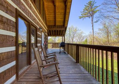 Outskirts of Heaven wrap around deck with rocking chairs