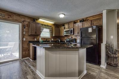 Rustic Acres kitchen island and fully furnished kitchen