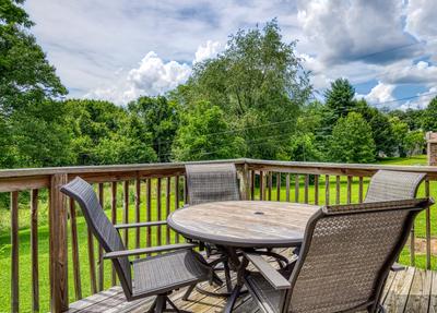 Rustic Acres back deck with table and chairs