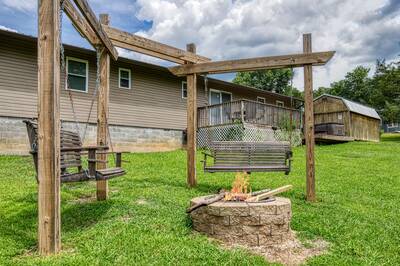 Rustic Acres fire pit and swings