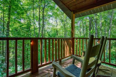 Unforgettable covered back deck with rocking chairs