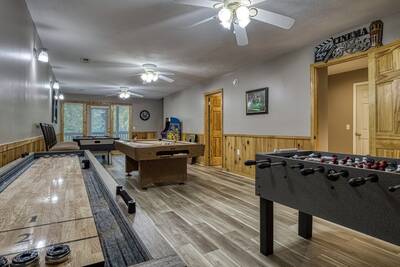Striking Waters game room with shuffle board table
