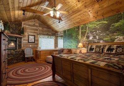 Antler Crossing upper level bedroom with stone encased gas fireplace