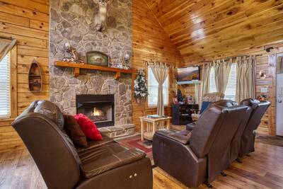 Three bears living room with stone encased gas fireplace