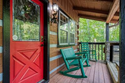 Whispering Winds covered entry deck with rocking chairs