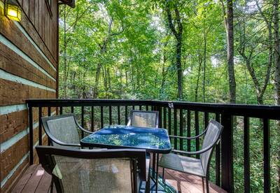 Whispering Winds back deck with table and chairs