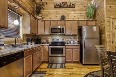 River Haven fully furnished kitchen with stainless steel appliances