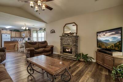 River Escape living room with stone encased gas fireplace