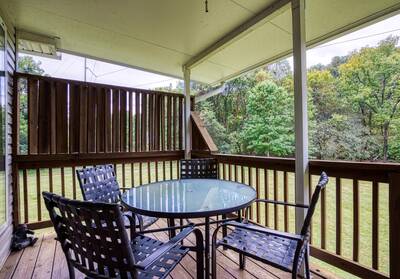 River Escape covered back deck with table and chairs
