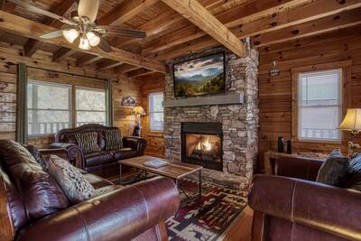 View to Remember living room with stone encased gas fireplace