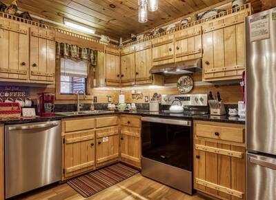 Mountain Magic fully furnished kitchen with stainless steel appliances