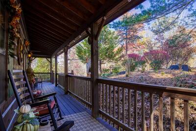 Mountain Magic covered entry deck with rocking chairs