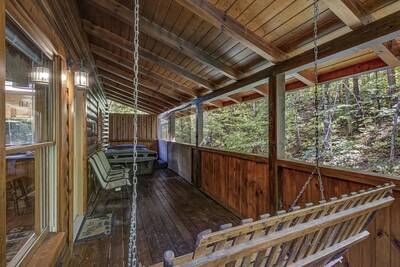 Creekview covered back deck with swing and hot tub