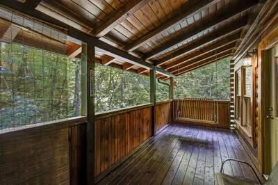 Creekview covered back deck with swing