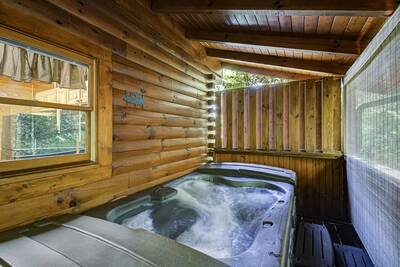 Creekview covered back deck with hot tub