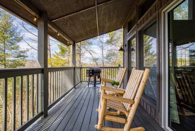 Peak of Perfection covered back deck with rocking chairs