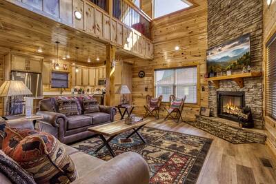 Cozy Cub Cabin living room with stone encased gas fireplace