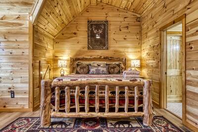 Cozy Cub Cabin upper level loft area with king size bed