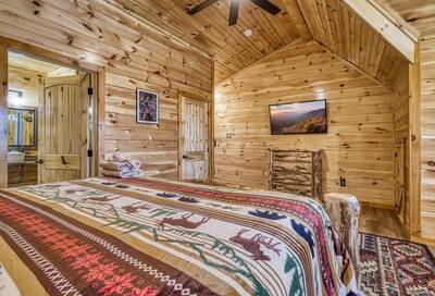 Cozy Cub Cabin upper level bedroom with 55 inch TV