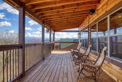 Cozy Cub Cabin upper level deck with rocking chairs
