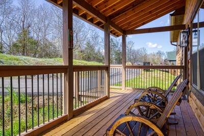 Cozy Cub Cabin covered entry deck with rocking chairs