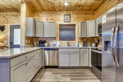 Singing in the Smokies fully furnished kitchen with granite countertops and stainless steel appliances