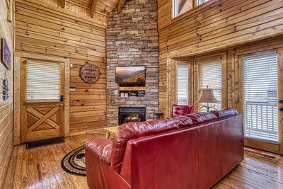 River Cabin living room with stone encased gas fireplace