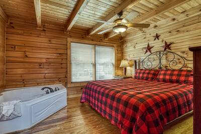 River Cabin bedroom with king bed and en suite jetted tub