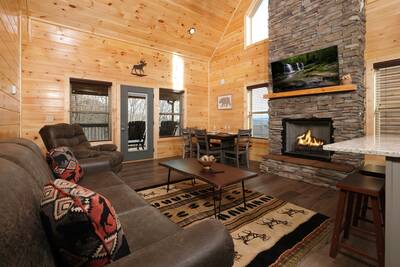 Pine View Lodge living room with stone encased seasonal gas fireplace