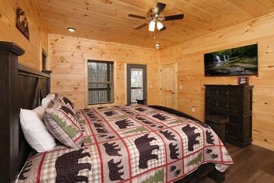 Pine View Lodge main level bedroom with king size bed and 50 inch TV