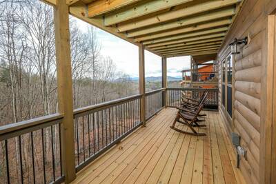 Pine View Lodge main level covered back deck with rocking chairs