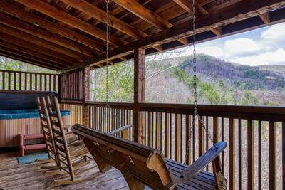 Old Glory covered back deck with swing and mountain views
