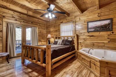 Katies Lodge main level bedroom with queen bed and whirlpool tub