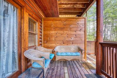 Another Day Inn Bearadise lower level back deck with wicker furniture
