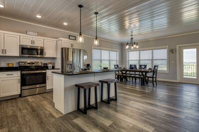 Lake View Therapy kitchen island, fully furnished kitchen, and dining area