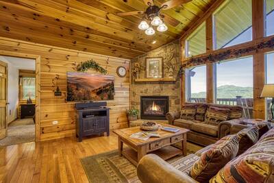 Getaway Mountain Lodge living room with seasonal stone encased gas fireplace
