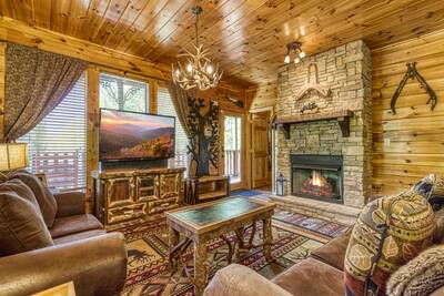 Antler Run living room with seasonal stone encased gas fireplace