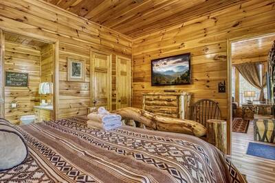 Antler Run main level bedroom one with king bed and flat screen TV