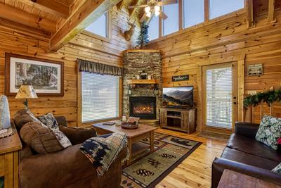 A Stone's Throw living room with seasonal stone encased gas log fireplace