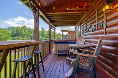 A Stone's Throw covered back deck with high top table and chairs