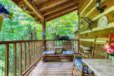 Striking in the Smokies covered entry deck with love seat glider