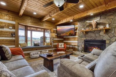 Secluded Summit living room with seasonal stone encased gas fireplace