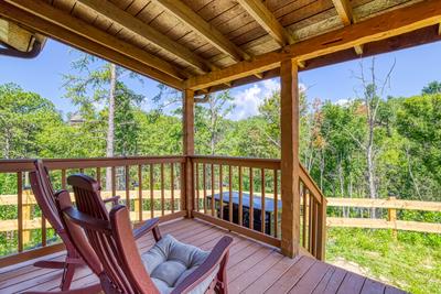 Secluded Summit covered back deck with rocking chairs