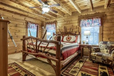 Blue Sky main level bedroom with king size bed and chair