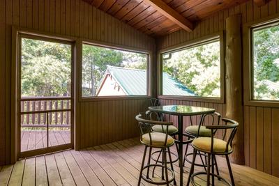 Blue Sky screened in back deck with hightop table and chairs