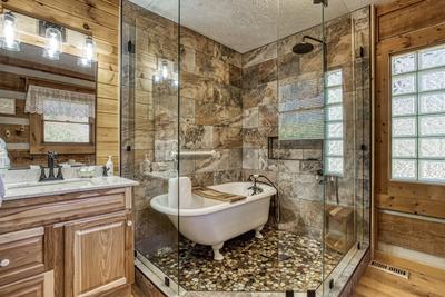 4 Paws Lodge master bathroom with walk in shower and spa soaking tub