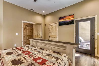 The Lodge at Burg Hill main level bedroom three with king bed and 50 inch TV