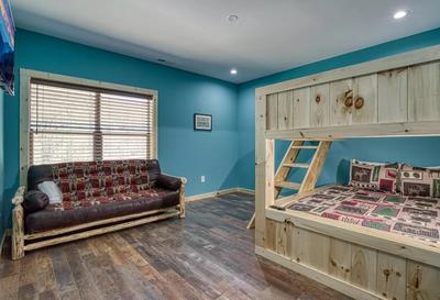 The Manor at Burg Hill upper level bedroom with queen over queen bunk beds and futon