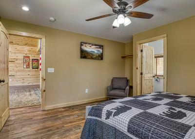 The Manor at Burg Hill upper level bedroom with king size bed and 43 inch TV